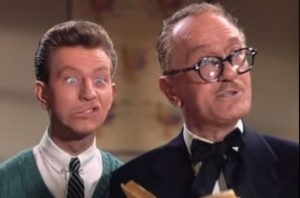 Bobby Watson in Singin' in the Rain, with onald O'Connor mugging behind him.