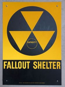 The triangles-within-a-circle were the universal designation for a fallout shelter. (Wikipedia)