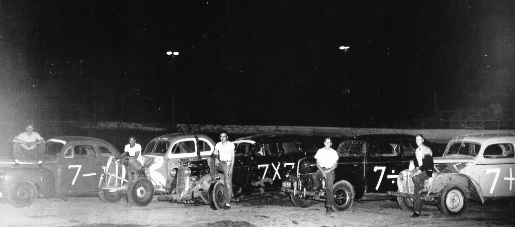 Shaheen's Springfield Speedway, 1955 . From left: Norm Scantlin, Chuck Hubbard, Jim Brown, Bob Sager, Art 'Buster' Zellers. Hubbard was the first African-American driver to make a bid in local stock car racing. (Sangamon Valley Collection)