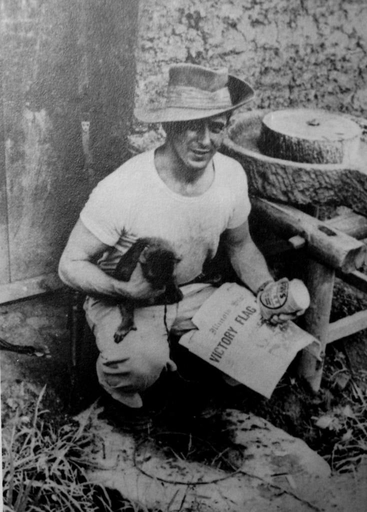 Meredith Rhule with his pet monkey, Dudley, in 1945. The newspaper on Rhule's lap appears to be the May 1, 1945 edition of the Illinois State Journal.