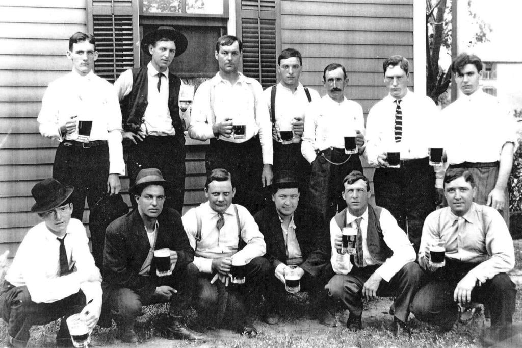 Bartender John Howard is in the top row, third from left, in this photo taken at 1315 E. Enterprise St., next door to the Noll Saloon (Courtesy Kyle Graham)
