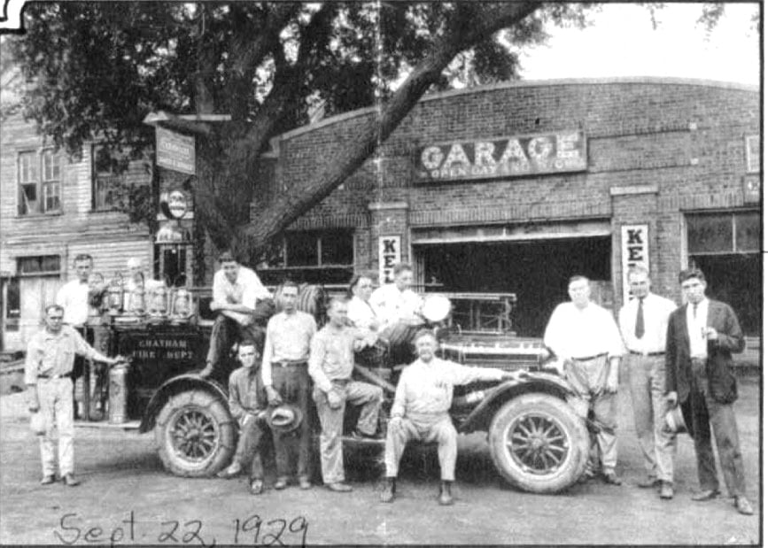 113 W. Mulberry St., Chatham -- then the Everett Cary garage -- is the background of this 1929 photo of the Chatham Fire Department (courtesy Keith Sculle)