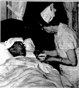 Jack Lum receives a drink from nurse Anne Squyer following his "hibernation therapy," 1939 (SJR)