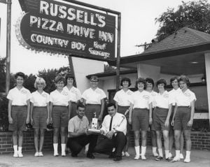 The sign says Russell's, but the logos on the shirts of this champion softball team says Angelo's (Courtesy Sangamon Valley Collection)