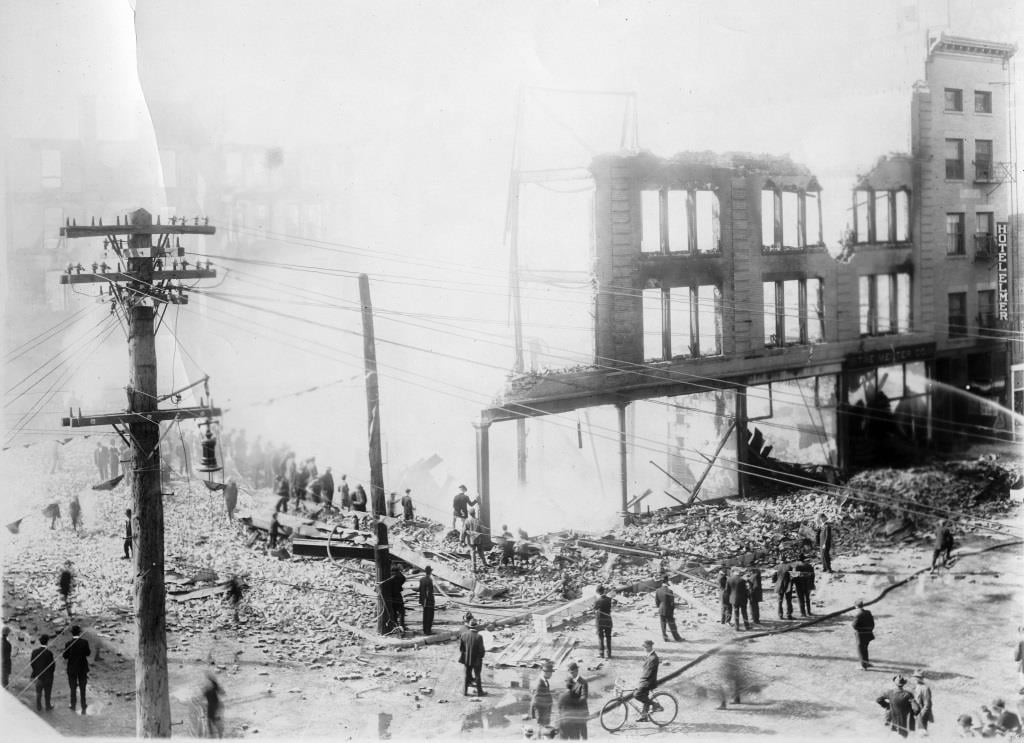 Spectators watch as firefighters extinguish the smoldering ruins of the Johnston-Hatcher Co. home furnishings store after it burnt down for a second time in 1913 (Sangamon Valley Collection)