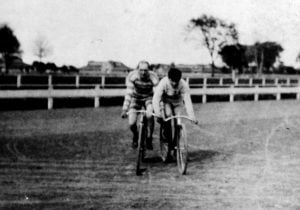 Alfred J. Mester, left, of the Capital City Cycling Club in a "safety bicycle" race at the Illinois State Fairgrounds about 1900 (Sangamon Valley Collection)