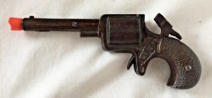 Images of lethal toy pistols from the 1880s are rare, but they probably resembled this 1880s' cap gun (minus the modern orange muzzle plug). Cap guns did not use the dangerous cartridges (eBay)